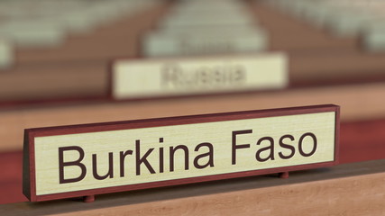 Burkina Faso name sign among different countries plaques at international organization. 3D rendering