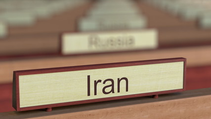 Iran name sign among different countries plaques at international organization. 3D rendering