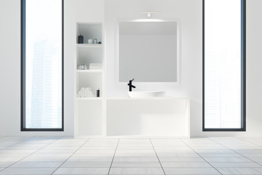 White bathroom, sink and a square mirror