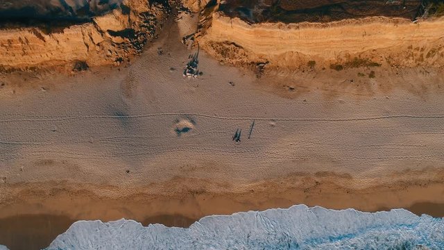 Aerial top shot of sandy golden beach waves and turquoise ocean. Perfect for wordpress website video background or nature travel video