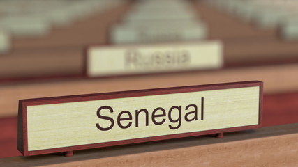 Senegal name sign among different countries plaques at international organization. 3D rendering