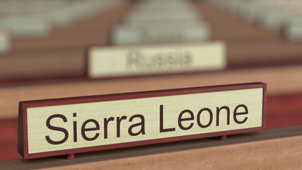 Sierra Leone name sign among different countries plaques at international organization. 3D rendering
