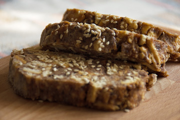 chocolate dessert with sesame seeds sliced on wooden background