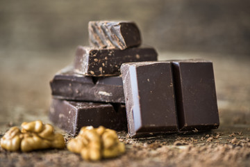 Dark Chocolate Pieces Stack on Rustic Background