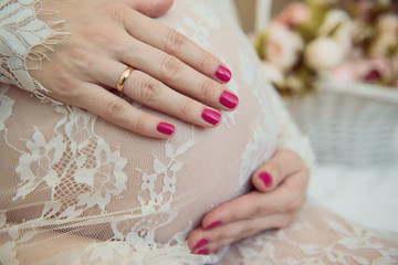 Pregnant girl hugging her belly