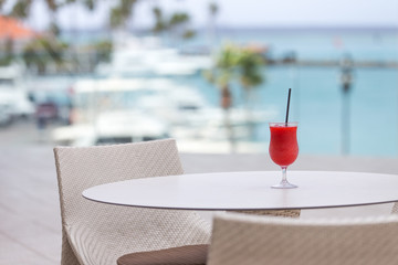 A tropical drink on a table at a seaside restaurant