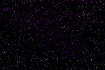 Violet-black space of the cosmos with stars.