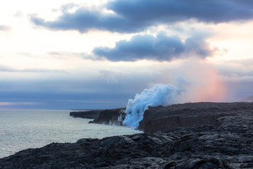 Fototapeta na wymiar Volcano lava tube spilling into the ocean at dusk