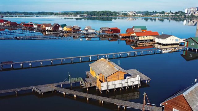 Aerial panorama of traditional fishing houses line on the lake shore, Hungary.