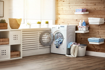 Interior of real laundry room with  washing machine at window at home - obrazy, fototapety, plakaty