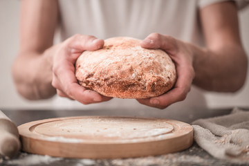 fresh bread in hands closeup on