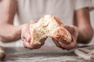 fresh bread in hands closeup on