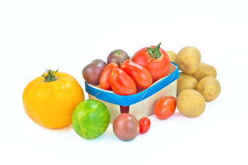 Assortment organic vegetable colorful tomatoes and potatoes isolated on white background