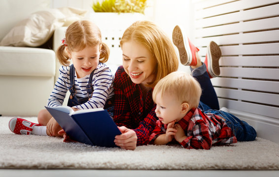 Mother reads book to children