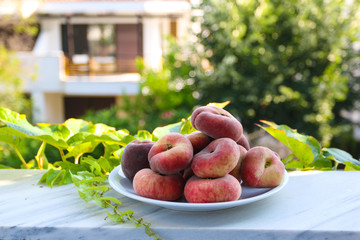 Ripe peach on plate. Nature background. Summer concept.