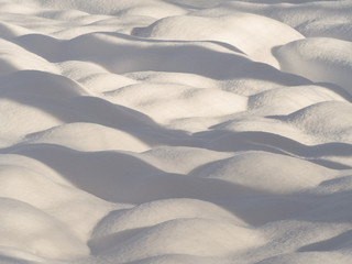 Fototapeta na wymiar Sanfte Schneebuckel mit Schatten im Winter