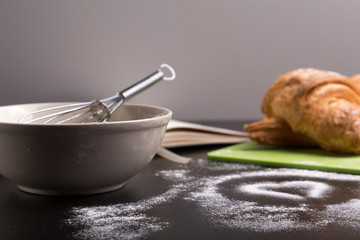 freshly baked croissants on green cutting board with flour
