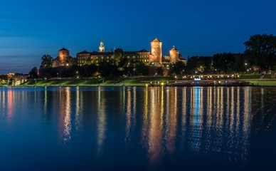 Fototapeta na wymiar Krakow, Poland, panorama of Wawel Castle from the Vistula river boulevards in the evening