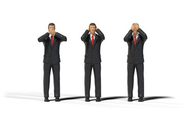 3 miniature figure businessmen in a three wise monkeys pose isolated on white background (see no...