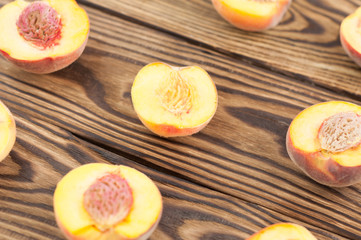 Rows of halves of peach on rustic old wooden planks