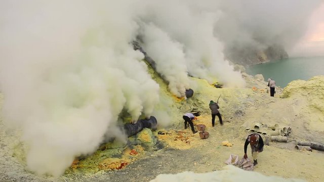 Sulfur miners inside crater of Ijen volcano in East Java, Indonesia timelapse.