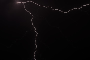 Two strains of lighting in the clouds electricity transfer violent sound from the sky with...