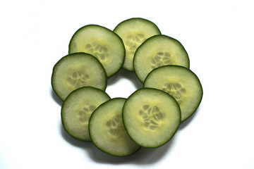 Closeup of cucumber slices on a white background