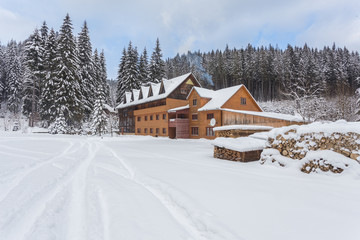 wooden houses on austrian mountains at winter