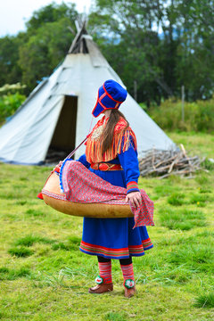 Northern Norway, A Traditional Dressed Sami Woman With A Cradle