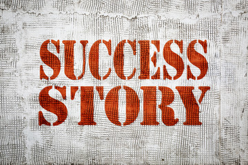 success story sign painted on grunge stucco texture wall