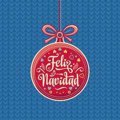 Feliz Navidad.  Red Christmas ball with good wishes in Spanish. 