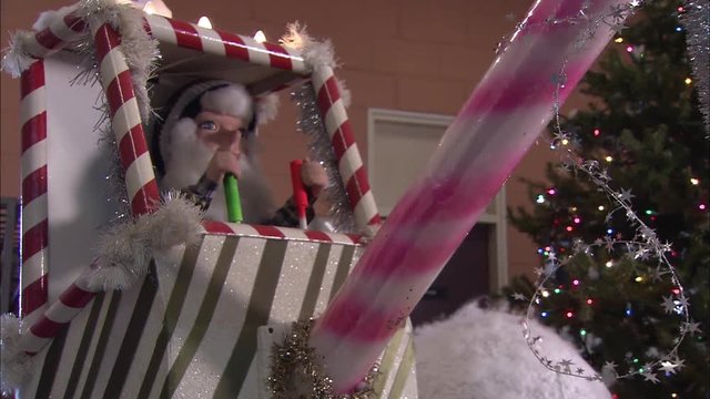 Animated Christmas decoration with elf on candy cane crane.