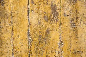 Weathered yellow paint on wood