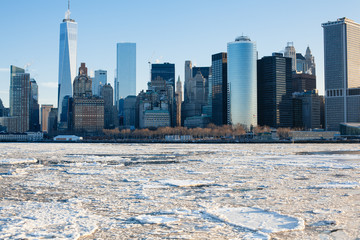 Fototapeta na wymiar Lower manhattan Hudson RIver frozen due to extreme cold weather. Climate change. Unpredictable weather.