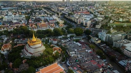  'Golden Mountain '  Wat Saket Ratcha Wora Maha Wihan popular Bangkok tourist attraction , Landmarks of bangkok Thailand . In the rain before , topview