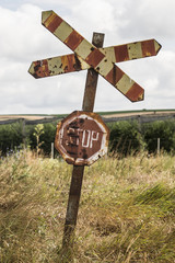 Old and rusty railroad sign with stop letters