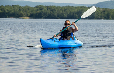 woman kayaking on a calm lake