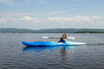 woman kayaking on a calm lake