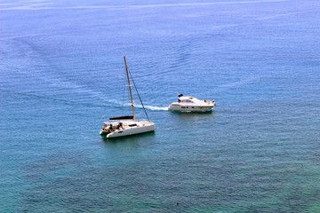 Two white sea yachts in the city harbor near the coast (Antalya, Turkey).