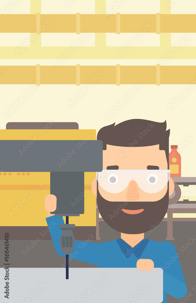 Poster a hipster man with the beard working with a drilling machine on the background of factory workshop w
