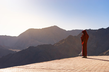 Lama (Tibetan monk) gazing the mountain range and blue sky in Leh Ladakh © jumpscape