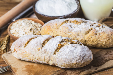 Freshly baked traditional bread on wooden table Oatmeal Bread