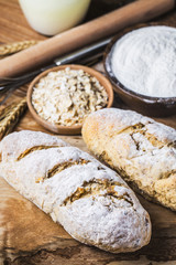 Freshly baked traditional bread on wooden table Oatmeal Bread