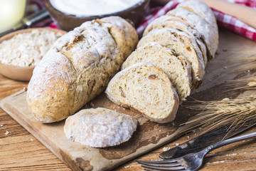 Freshly baked traditional bread on wooden table Oatmeal Bread