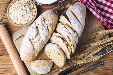 Freshly baked traditional bread on wooden table Oatmeal Bread