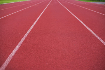 Fototapeta premium Red running track in stadium,Plastic track in the playground