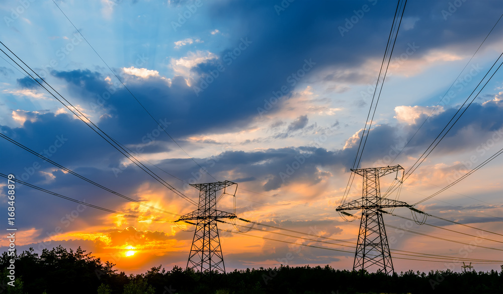 Wall mural high-voltage power lines at sunset. electricity distribution station. high voltage electric transmission tower.