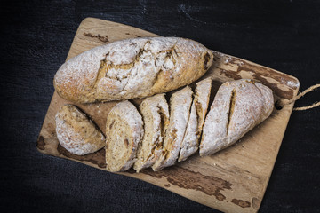 Freshly baked traditional bread on wooden table Oatmeal Bread
