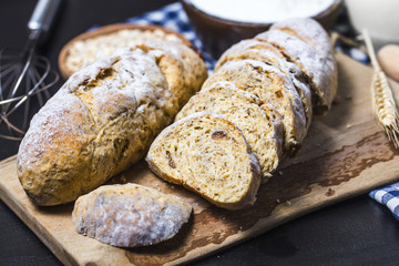 Freshly baked traditional bread on wooden table Oatmeal Bread