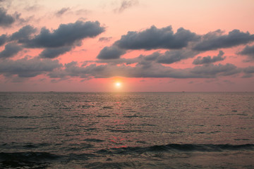 Dark sunset sky over a calm sea.